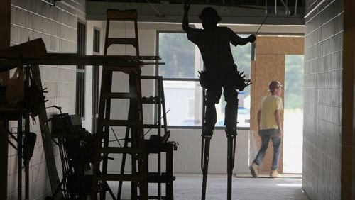 SCHOOL WORK--Evergreen construction and sub-contractor crews work on the ceiling, windows, painting and electrical inside the new elementary school that is scheduled to be completed in the fall. The new building will have 77 classrooms on about 38 acres of land. Cherokee County schools are moving forward with an ELOST vote in November. We take a look at this new elementary school in construction along Hunt Road in Acworth Wednesday, May 25, 2011.