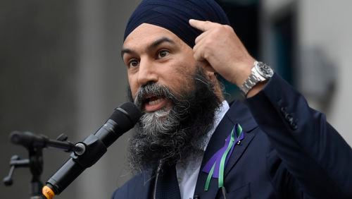 FILE - New Democratic Party leader Jagmeet Singh points to his turban as he speaks about racism during a speech in London, Ontario, June 8, 2021. (Nathan Denette/The Canadian Press via AP, File)