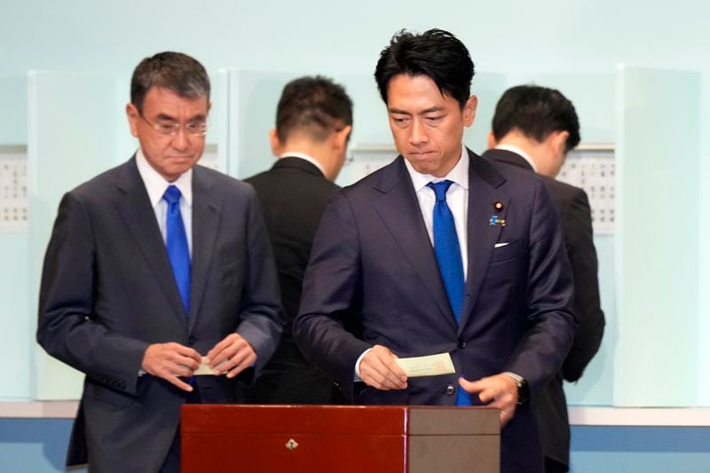 One of candidates, Shinjiro Koizumi, right, casts his ballot at the ruling Liberal Democratic Party's (LDP) leadership election at the party headquarters, Friday, Sept. 27, 2024, in Tokyo. (AP Photo/Hiro Komae, Pool)