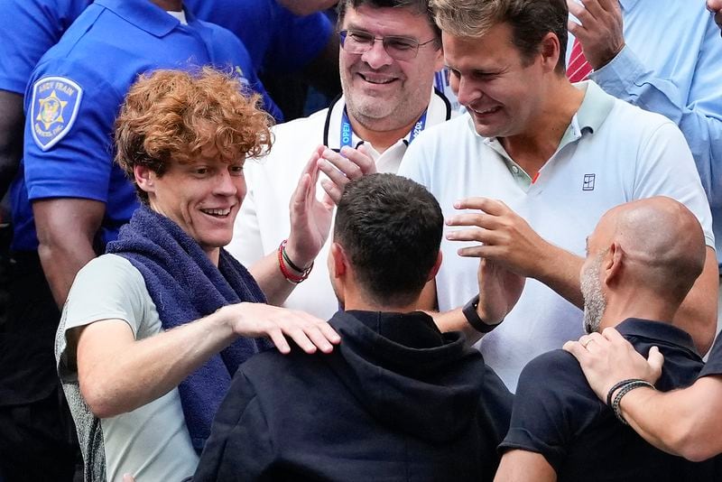 Jannik Sinner, of Italy, celebrates with members of his team after defeating Taylor Fritz, of the United States, in the men's singles final of the U.S. Open tennis championships, Sunday, Sept. 8, 2024, in New York. (AP Photo/Kirsty Wigglesworth)