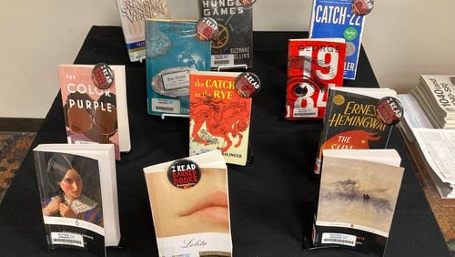 The "book sanctuary" table at the Fort Lauderdale Reading Center, a branch of the Broward County Library, on Tuesday, May 23, 2023. Identified by a sign explaining it was  "A Safe Place for Stories," the table had copies of 11 books, including “The Color Purple,” “The Catcher in the Rye,” “Catch-22,” “The Sun Also Rises” and “The Hunger Games.” (Anthony Man/South Florida Sun Sentinel/TNS)