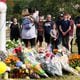 Mourners visit a memorial on Sept. 6 at Apalachee High. Students around Georgia have planned walkouts for tougher gun safety laws. (Jason Getz/The Atlanta Journal-Constitution/TNS)