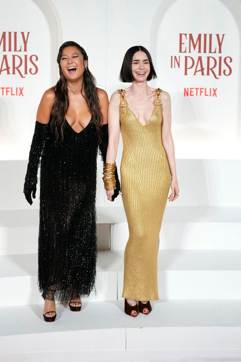 Actresses Ashley Park, left, and Lily Collins arrive at the premiere of "Emily in Paris", in Rome, Tuesday, Sept. 10, 2024. (AP Photo/Andrew Medichini)