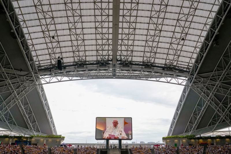 Pope Francis presides over a mass 'In Memory of the Most Holy Name of Mary' celebrated by the Archbishop of Singapore, Cardinal William Goh Seng Chye at the Singapore SportsHub National Stadium, Thursday, Sept. 12, 2024. In Singapore, his final stop of an 11-day trip to Asia and Oceania, Francis once again ditched his remarks when he arrived at the last event, a meeting of Singaporean youth on Friday morning."That's the talk I prepared," he said, pointing to his speech and then proceeding to launch into a spontaneous back-and-forth with the young people about the need to have courage and take risks. (AP Photo/Gregorio Borgia)