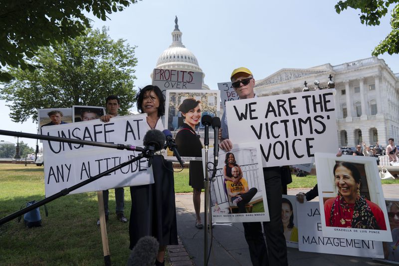 Chris and Clariss Moore parents of Danielle, one of the 157 crash victims of a Boeing 737 MAX8 in Ethiopia, holding her photographs, speaks during a news conference on Capitol Hill, Tuesday, June 18, 2024, in Washington. ( AP Photo/Jose Luis Magana)