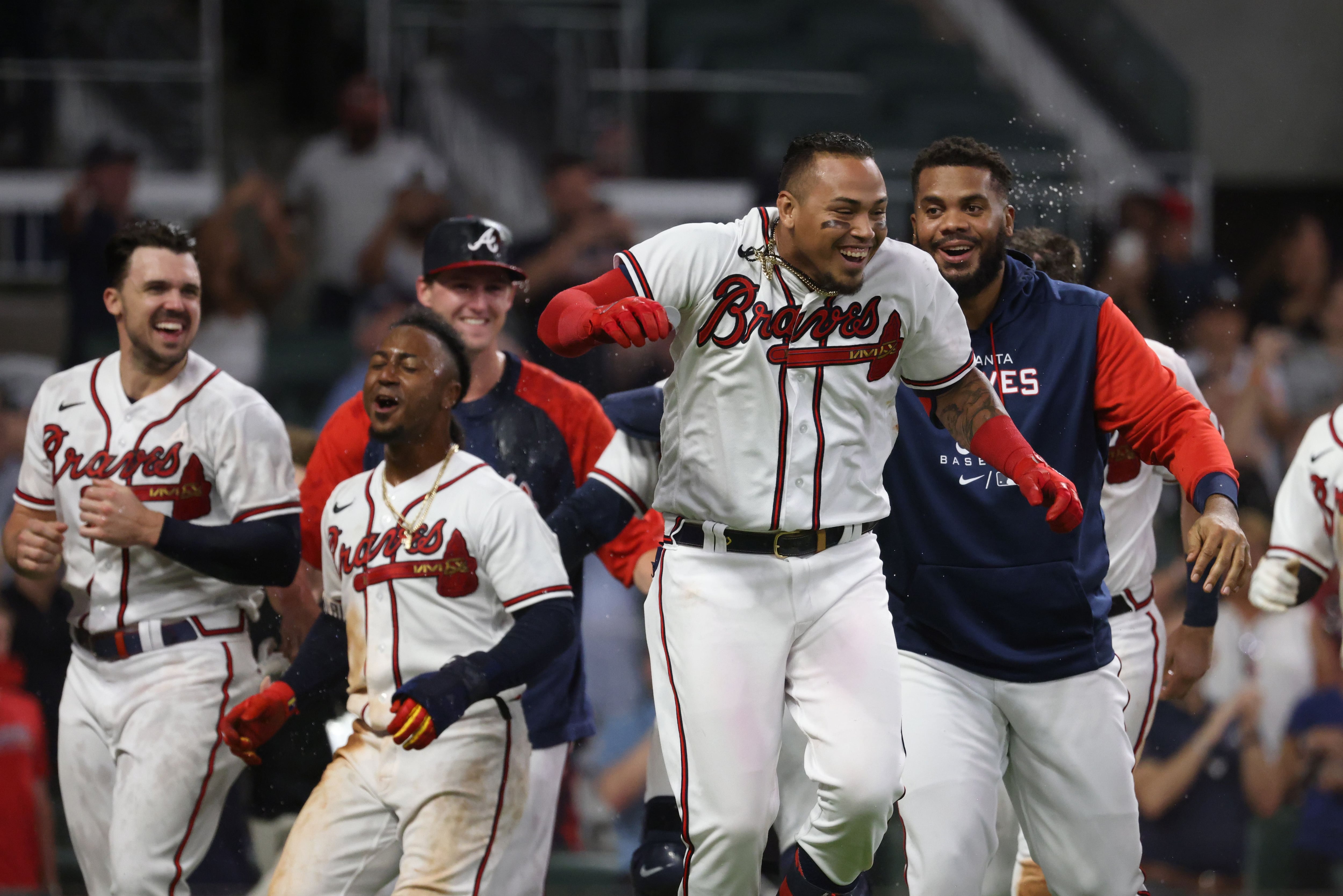 ATLANTA, GA - APRIL 06: Atlanta Braves shortstop Orlando Arcia (11)  celebrates with his team after hitting a walk-off base hit during the Braves  2023 home opener MLB game between the Atlanta