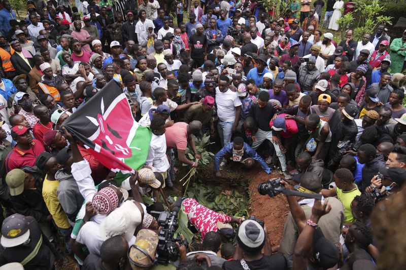 Relatives and friends bury the body of 19-year-old Ibrahim Kamau, at the Kariakor cemetery in Nairobi, Kenya Friday, June 28, 2024. Kamau was shot during a protest on Tuesday against the government proposed tax bill. Protesters stormed parliament on Tuesday and drew police fire in chaos that left several people dead, reportedly as many as 22. (AP Photo/Brian Inganga)