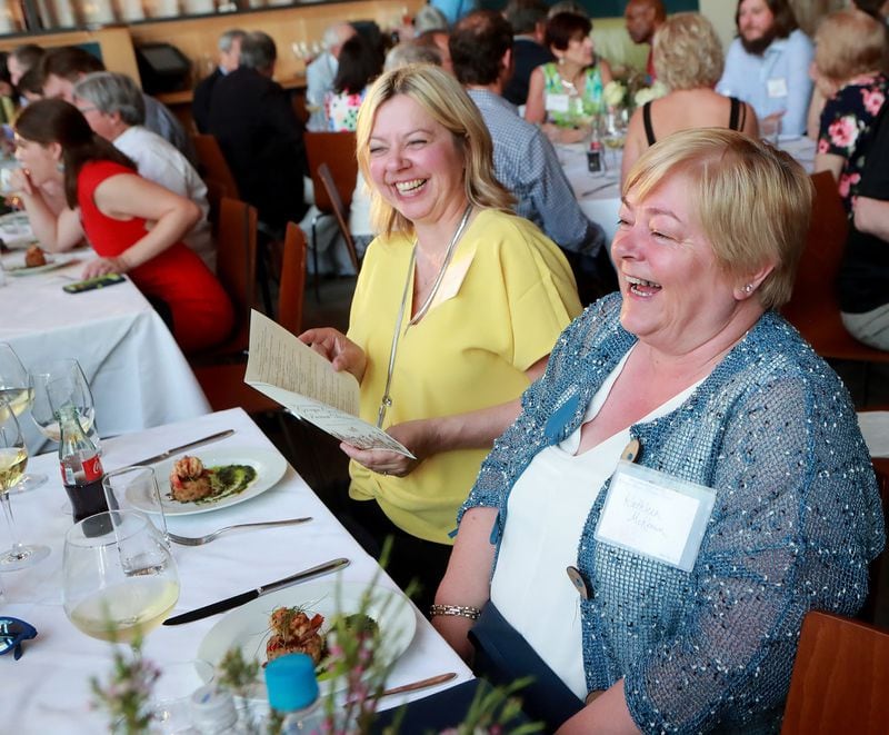 Guests Lisa Love (left) and Kathleen McKeown share a laugh while enjoying their meal during a May 28 preview dinner at White Oak Kitchen & Cocktails in Atlanta for the Georgia Grown dinner in New York City. CURTIS COMPTON / CCOMPTON@AJC.COM