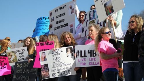 Family members and classmates of two high school girls killed in a wreck involving a state trooper stage a protest Friday in Carrollton, two days after a county grand jury decided not to bring charges against the trooper. TAYLOR CARPENTER / TAYLOR.CARPENTER@AJC.COM