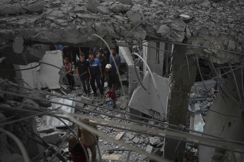 Palestinians examine a destroyed mosque following an Israeli airstrike in Deir al-Balah, Sunday, Oct. 6, 2024. (AP Photo/Abdel Kareem Hana)