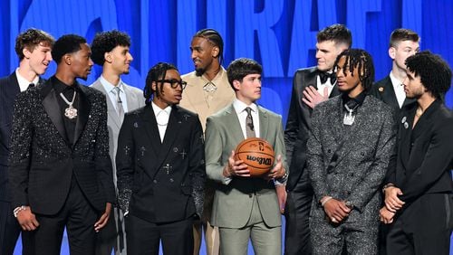Zaccharie Risacher talks with Alex Sarr as they stand on the stage for a group photograph ahead of the first round of the 2024 NBA Draft at Barclays Arena on Wednesday, June 26, 2024 in Brooklyn, NY. (Hyosub Shin / AJC)