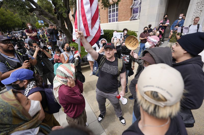 Demonstrators argue opposing views on the Israel-Hamas war on the UCLA campus Thursday, May 23, 2024, in Los Angeles. (AP Photo/Ryan Sun)