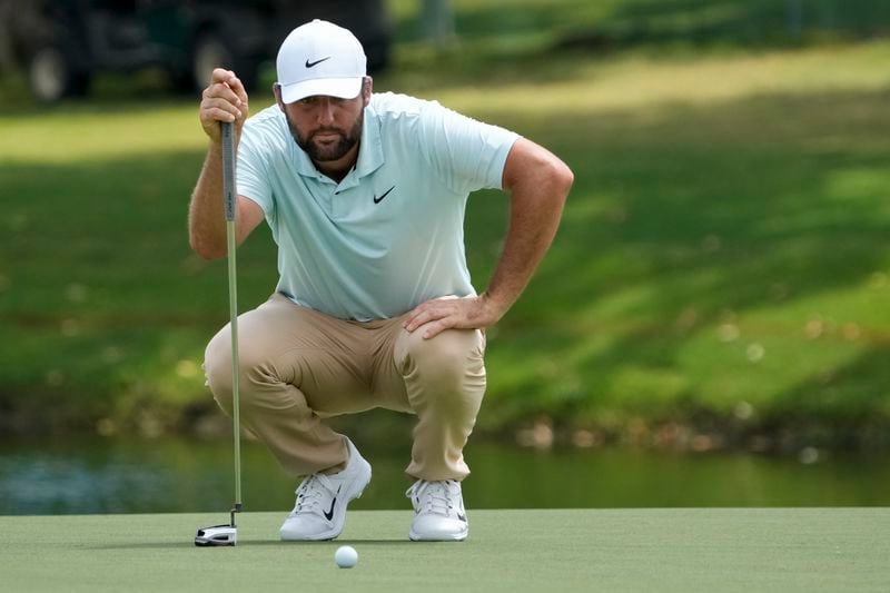 Scottie Scheffler lines up his putt on the 18th green during the second round of the St. Jude Championship golf tournament Friday, Aug. 16, 2024, in Memphis, Tenn. (AP Photo/Mark Humphrey)