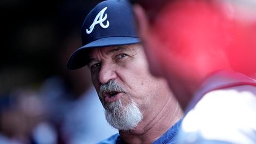 Atlanta Braves pitching coach Rick Kranitz talks with starter Max Fried in the dugout after the third inning of a baseball game against the Chicago Cubs Friday, Aug. 4, 2023, in Chicago. (AP Photo/Charles Rex Arbogast)