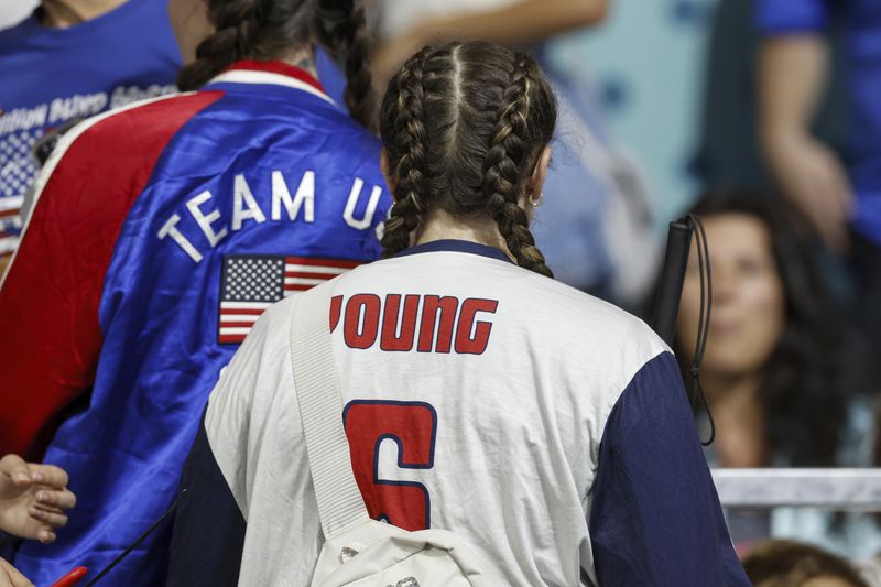 Eliana Mason, fiancé of American goalball team captain Callahan Young, wears a jersey displaying Young's name during the mens' United States versus France goalball game at the Paralympic Games in Paris, Saturday, Aug. 31, 2024. (AP Photo/Felix Scheyer)