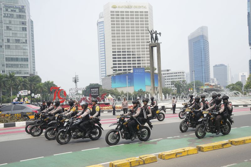 Police on motorcycles patrol on the street in Jakarta, Indonesia, Tuesday, Sept. 3, 2024. (AP Photo/Tatan Syuflana)