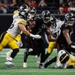 Atlanta Falcons running back Bijan Robinson (7) breaks a tackle during the second half of an NFL football game against the Pittsburgh Steelers on Sunday, Sept. 8, at Mercedes-Benz Stadium in Atlanta. 
(Miguel Martinez/ AJC)