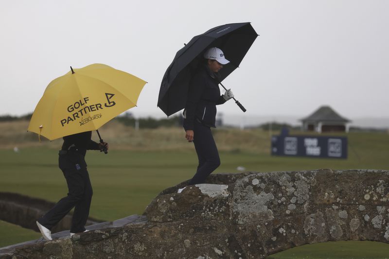 Lydia Ko, of New Zealand, walks over the Swilcan Bridge on the 18th hole during the final round of the Women's British Open golf championship, in St. Andrews, Scotland, Sunday, Aug. 25, 2024. (AP Photo/Scott Heppell)