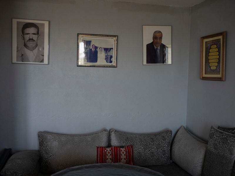 Family photos are displayed on the wall of the Ould Ibbat home in Marseille, southern France, Sunday, April 21, 2024. (AP Photo/Daniel Cole)
