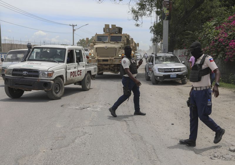 Police officers patrol a street near the airport in Port-au-Prince, Haiti, Thursday, Sept. 5, 2024. (AP Photo/Odelyn Joseph)