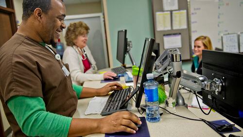 Horatio Henry (left), Rebecca Oller and Brooke Geeslin work on patient files at the CancerTreatmentCenters of America's Southeastern Regional Medical Center in Newnan.