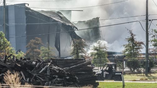 A large plume caused by a chemical reaction is still visible over the BioLab facility in Conyers, where a fire broke out Sunday.