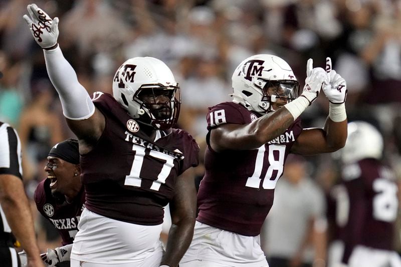 Texas A&M defensive lineman Albert Regis (17) and defensive lineman Cashius Howell (18) reacts after Notre Dame came up short on a fourth down play during the fourth quarter of an NCAA college football game Saturday, Aug. 31, 2024, in College Station, Texas. (AP Photo/Sam Craft)