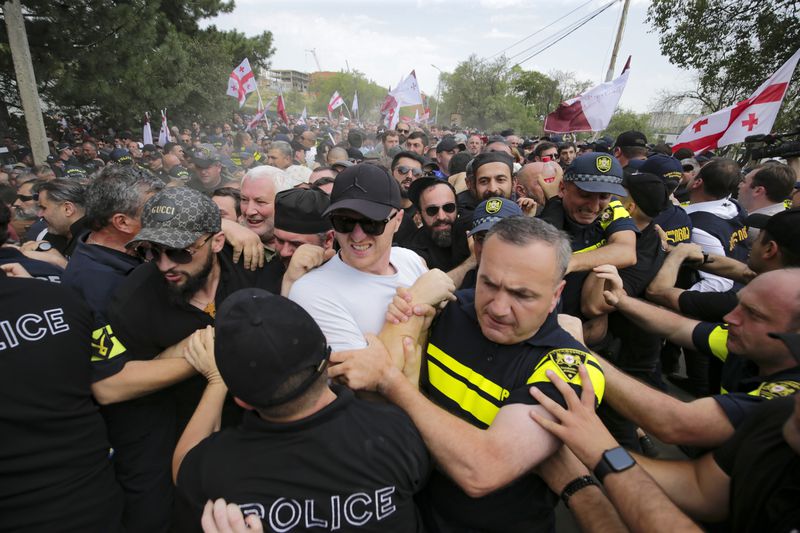 FILE - Police block opponents of gay rights as they try to interfere a pride event in Tbilisi, Georgia, on July 8, 2023. (AP Photo/Zurab Tsertsvadze, File)