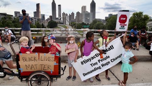 A protest group calling themselves the Tiny Activists marched to the Jackson Street bridge to lay flowers as demonstrations continued in metro Atlanta Sunday. Protests over the death of George Floyd in Minneapolis police custody continued around the United States, as his case renewed anger about others involving African Americans, police and race relations. (Photo: Steve Schaefer for The Atlanta Journal-Constitution)