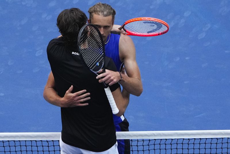 Taylor Fritz, of the United States, left, hugs Alexander Zverev, of Germany, after winning their quarterfinal match during U.S. Open tennis championships, Tuesday, Sept. 3, 2024, in New York. (AP Photo/Pamela Smith)