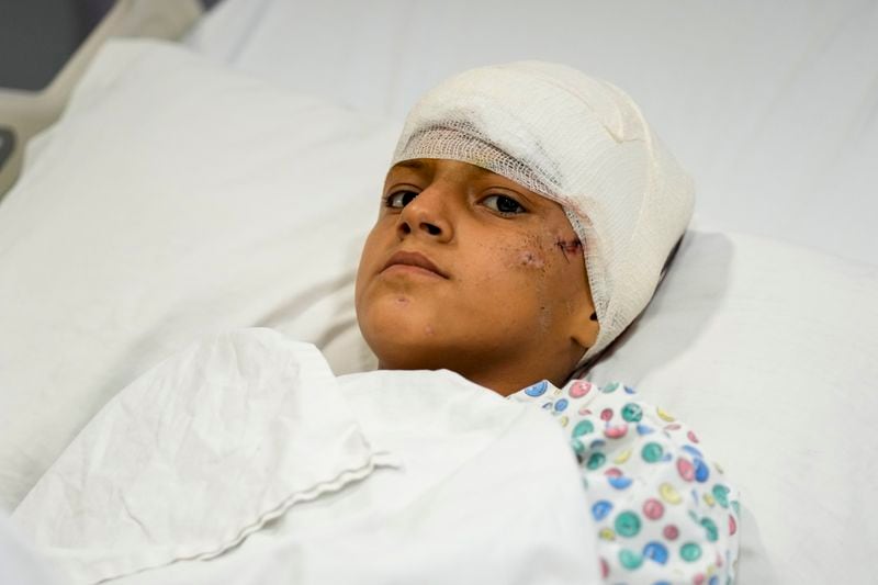 A girl who was wounded in an Israeli airstrike, lies in Rayak Hospital, in the village of Rayak, Bekaa Valley, eastern Lebanon, Saturday, Oct. 5, 2024. (AP Photo/Hassan Ammar)