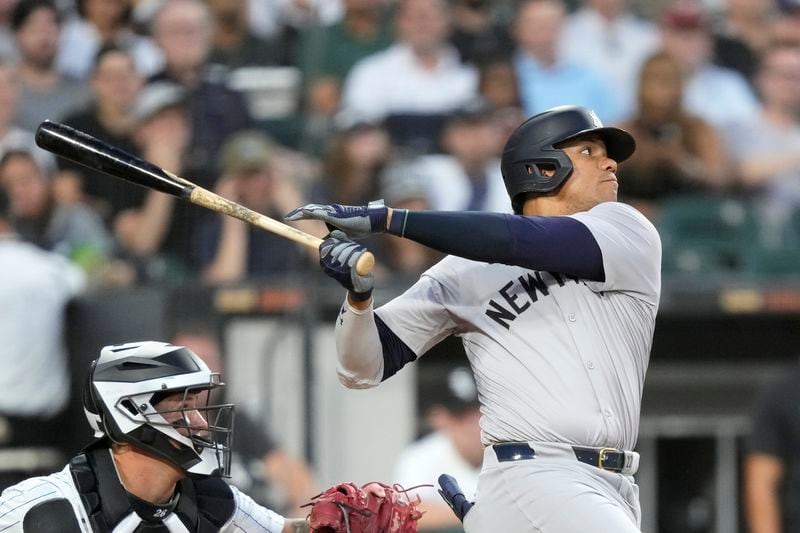 New York Yankees' Juan Soto watches his two-run home run off Chicago White Sox starting pitcher Jonathan Cannon during the third inning of a baseball game Tuesday, Aug. 13, 2024, in Chicago. (AP Photo/Charles Rex Arbogast)