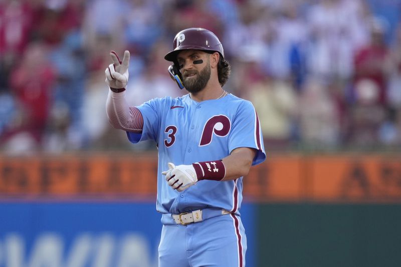 Philadelphia Phillies' Bryce Harper reacts after hitting a run-scoring double against Miami Marlins pitcher Trevor Rogers during the first inning of a baseball game, Thursday, June 27, 2024, in Philadelphia. (AP Photo/Matt Slocum)