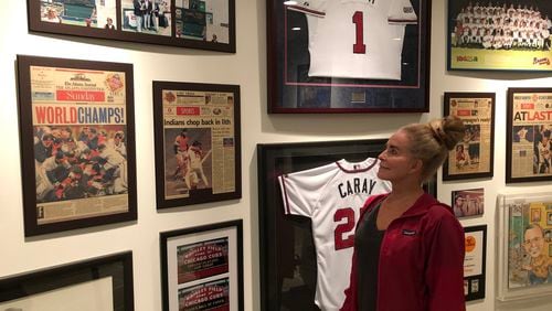 Skip Caray’s wife, Paula, in the basement of her Atlanta home, flanked by memories of 1995 and other seasons. (Photo by Steve Hummer)