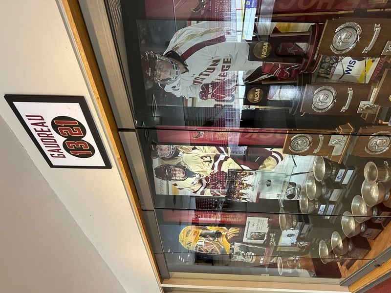 A sign hangs above the trophy case at Boston College's Conte Forum mourning the deaths of former Eagles hockey players Johnny and Matthew Gaudreau in Boston, Wednesday, Sept. 4, 2024. (AP Photo/Jimmy Golen)