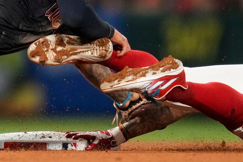 Los Angeles Angels' Zach Neto, right, is caught stealing second by Cleveland Guardians shortstop Brayan Rocchio, left, during the seventh inning of a baseball game in Anaheim, Calif., Saturday, May 25, 2024. (AP Photo/Ashley Landis)