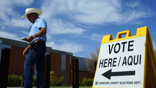 FILE - A voter walks to a voting precinct prior to casting his ballot in the state's primary election, Tuesday, July 30, 2024, in El Mirage, Ariz. (AP Photo/Ross D. Franklin, File)