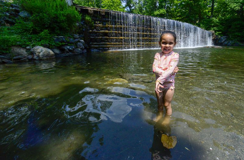 Madeline Kilduff, 4, plays at the Green River Timber Crib Dam in Guilford, Vt., on Wednesday, June 19, 2024. (Kristopher Radder /The Brattleboro Reformer via AP)