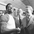 FILE - Georgia Gov. Jimmy Carter, right, and Delaware Gov. Sherman Tribbitt say hello to Atlanta Braves Hank Aaron, left, following a rain canceled game with the Los Angeles Dodgers in Atlanta, Ga., Sept. 27, 1973. (AP Photo, File)