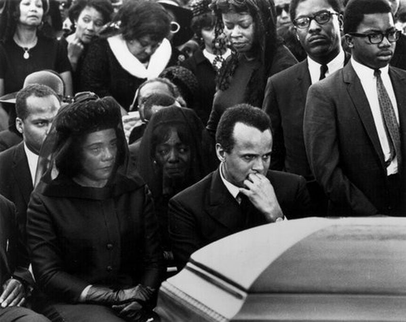 In this 1968 Atlanta Journal-Constitution photo by Noel Davis, Coretta Scott King sits with tears in her eyes at the funeral of her slain husband, Dr. Martin Luther King Jr. To her left sits Harry Belafonte. Images such as this illustrate how news photography has captured the most dramatic and moving moments in history and changed the way people view the world and current events. This photo, along with more than 100 others, was part of an exhibition of photographic moments in Atlanta history.