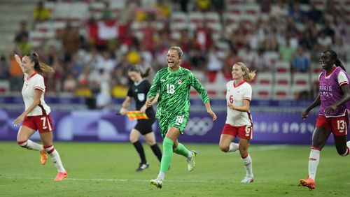 Canada goalkeeper Sabrina D'angelo celebrate with team members their side's 1-0 win after a women's Group A soccer match between Colombia and Canada, at the 2024 Summer Olympics, Wednesday, July 31, 2024, at the Nice Stadium in Nice, France. (AP Photo/Julio Cortez)