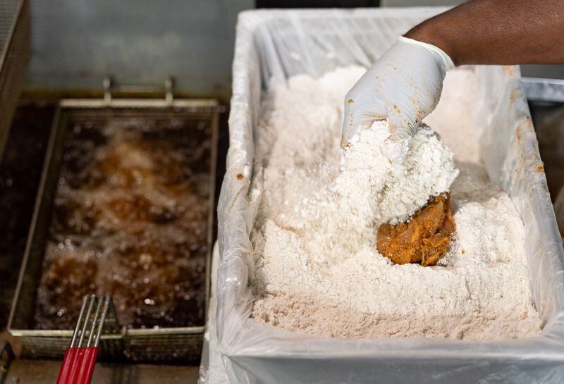 Jaybee’s Tenders co-founder William Harrington coats a chicken tender in breading at the restaurant in Decatur, GA on Thursday, July 25, 2024. (Seeger Gray / AJC)