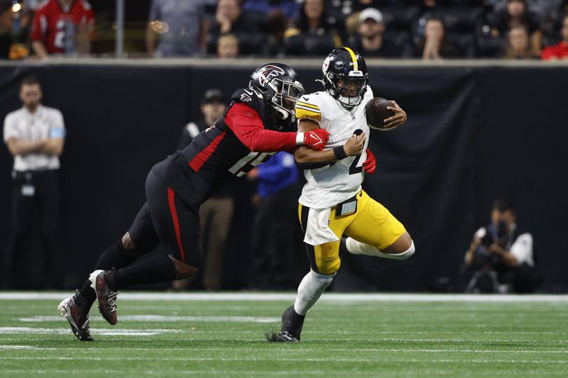 Pittsburgh Steelers quarterback Justin Fields (2) is stopped by Atlanta Falcons defensive tackle Kentavius Street (75) during the second half of an NFL football game Sunday, Sept. 8, 2024, in Atlanta. (AP Photo/Butch Dill)