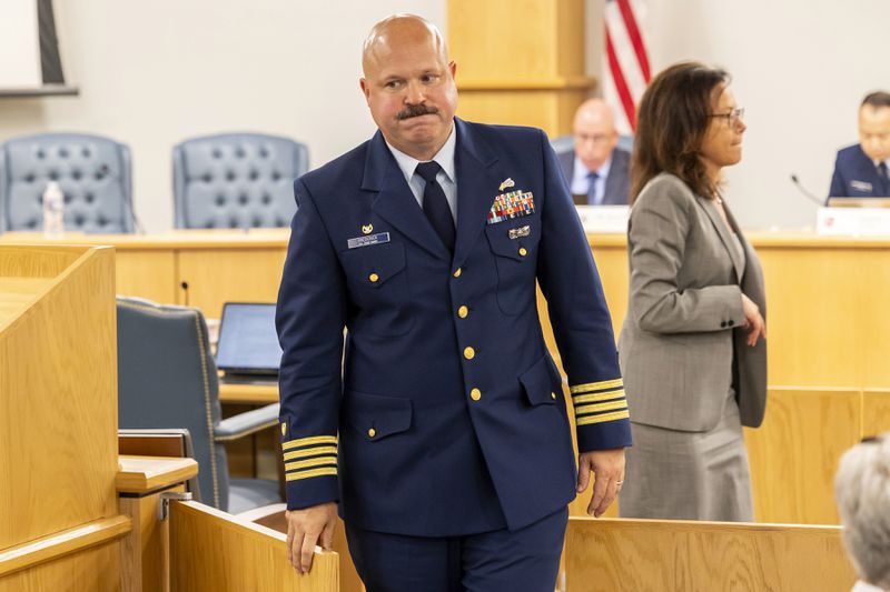 Captain Jamie Frederick, with the U.S. Coast Guard Sector Boston, leaves the hearing while in a break during the final day of the Coast Guard investigatory hearing on the causes of the implosion of an experimental submersible headed for the wreck of the Titanic, Friday, Sept. 27, 2024, in North Charleston, S.C. (AP Photo/Mic Smith)