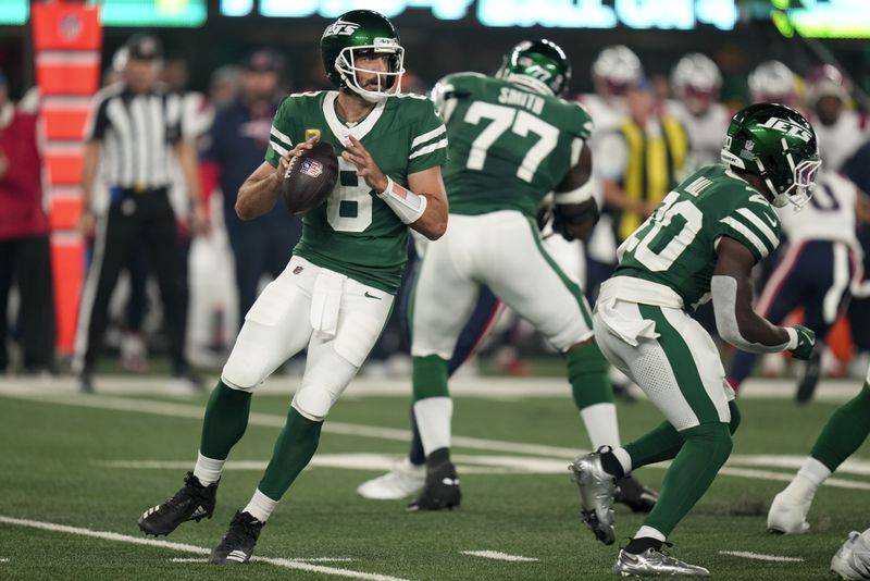 New York Jets quarterback Aaron Rodgers (8) steps back to pass against the New England Patriots during the first quarter of an NFL football game, Thursday, Sept. 19, 2024, in East Rutherford, N.J. (AP Photo/Seth Wenig)