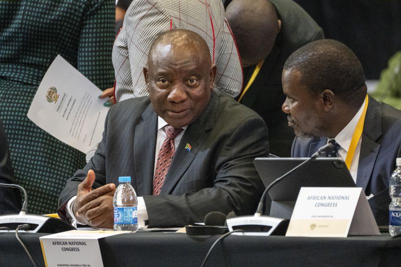 South African président Cyril Ramaphosa listens as members of Parliament are being sworn in ahead of an expected vote by lawmakers to decide if he is re-elected as leader of the country in Cape Town, South Africa, Friday, June 14, 2024. (AP Photo/Jerome Delay)