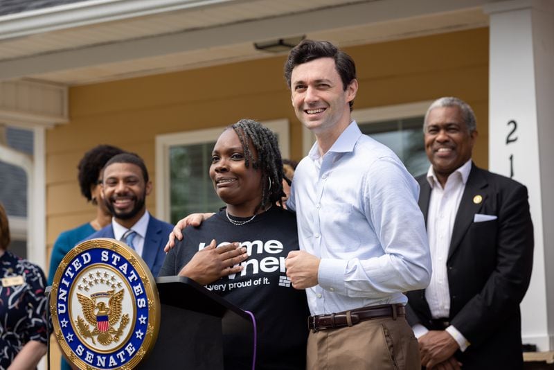 U.S. Sen. Jon Ossoff (right), D-Ga, stands with new homeowner Tanjills Sawyer at a press conference in Hampton on Monday, May 6, 2024 announcing federal funds for housing in Clayton County.(Arvin Temkar / AJC)