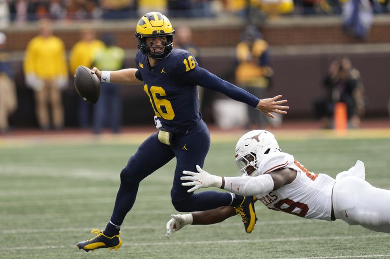 Michigan quarterback Davis Warren (16) throws under pressure from Texas linebacker Barryn Sorrell (88) in the second half of an NCAA college football game in Ann Arbor, Mich., Saturday, Sept. 7, 2024. (AP Photo/Paul Sancya)