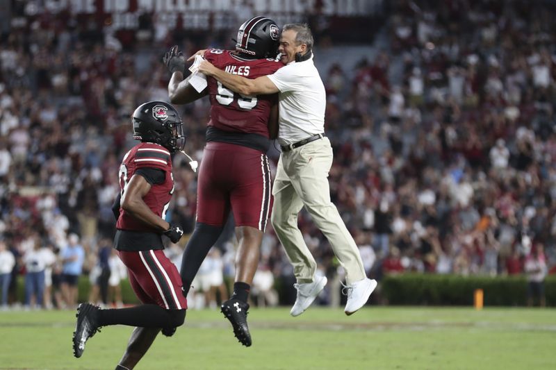 South Carolina head coach Shane Beamer celebrates a fumble recovery with defensive tackle DeAndre Jules (99) during the second half of an NCAA college football game against Old Dominion, Saturday, Aug. 31, 2024, in Columbia, S.C. (AP Photo/Artie Walker Jr.)