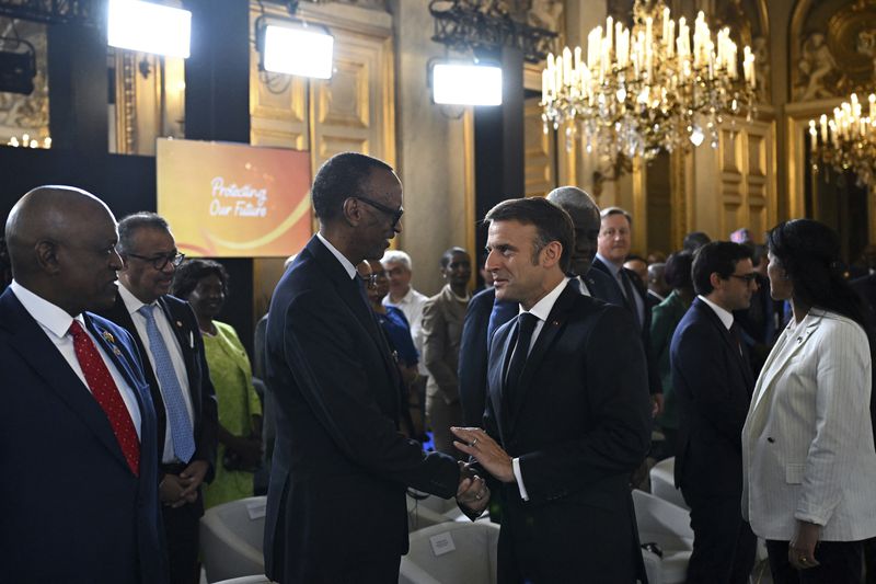French President Emmanuel Macron greets Rwanda's President Paul Kagame during the African Vaccine Manufacturing Accelerator conference, Thursday, June 20, 2024 in Paris. French President Emmanuel Macron is joining some African leaders to kick off a planned $1 billion project to accelerate the rollout of vaccines in Africa, after the coronavirus pandemic bared gaping inequalities in access to them. (Dylan Martinez/Pool via AP)